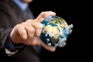 Businessman holding the world in the fingers