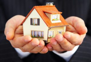 Hand of the businessman with the house