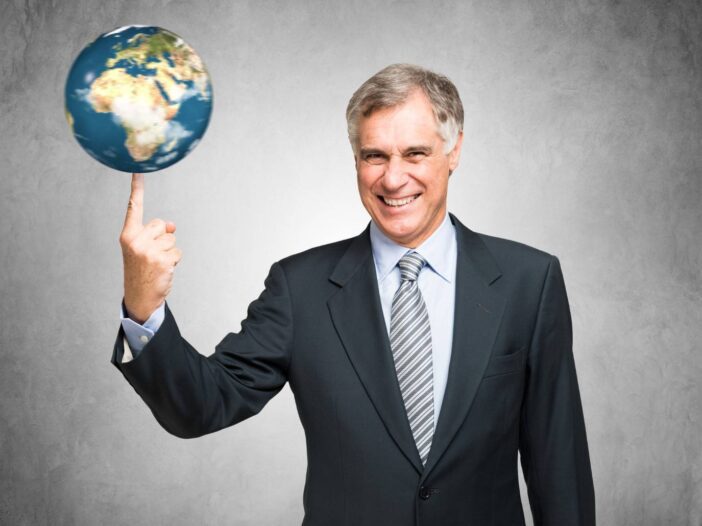 Businessman spinning a globe on his finger