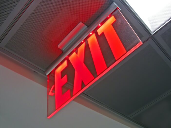 exit sign inside of silver surface, security details